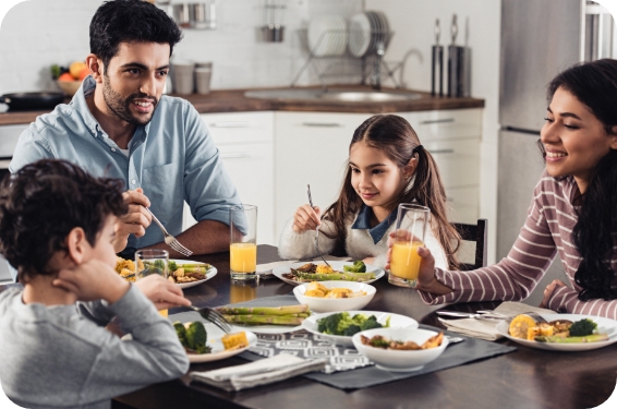 happy-hispanic-family-smiling-while-having-lunch-home